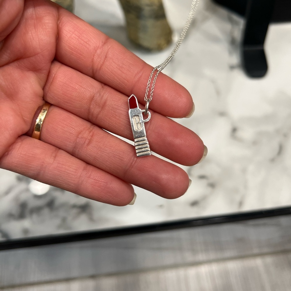 Sterling silver Tiffany & Co. Clinique lipstick pendant plus the 18 “ chain .